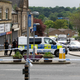 Police stand behind a cordon in Birstall near Leeds, where MP Jo Cox was killed.